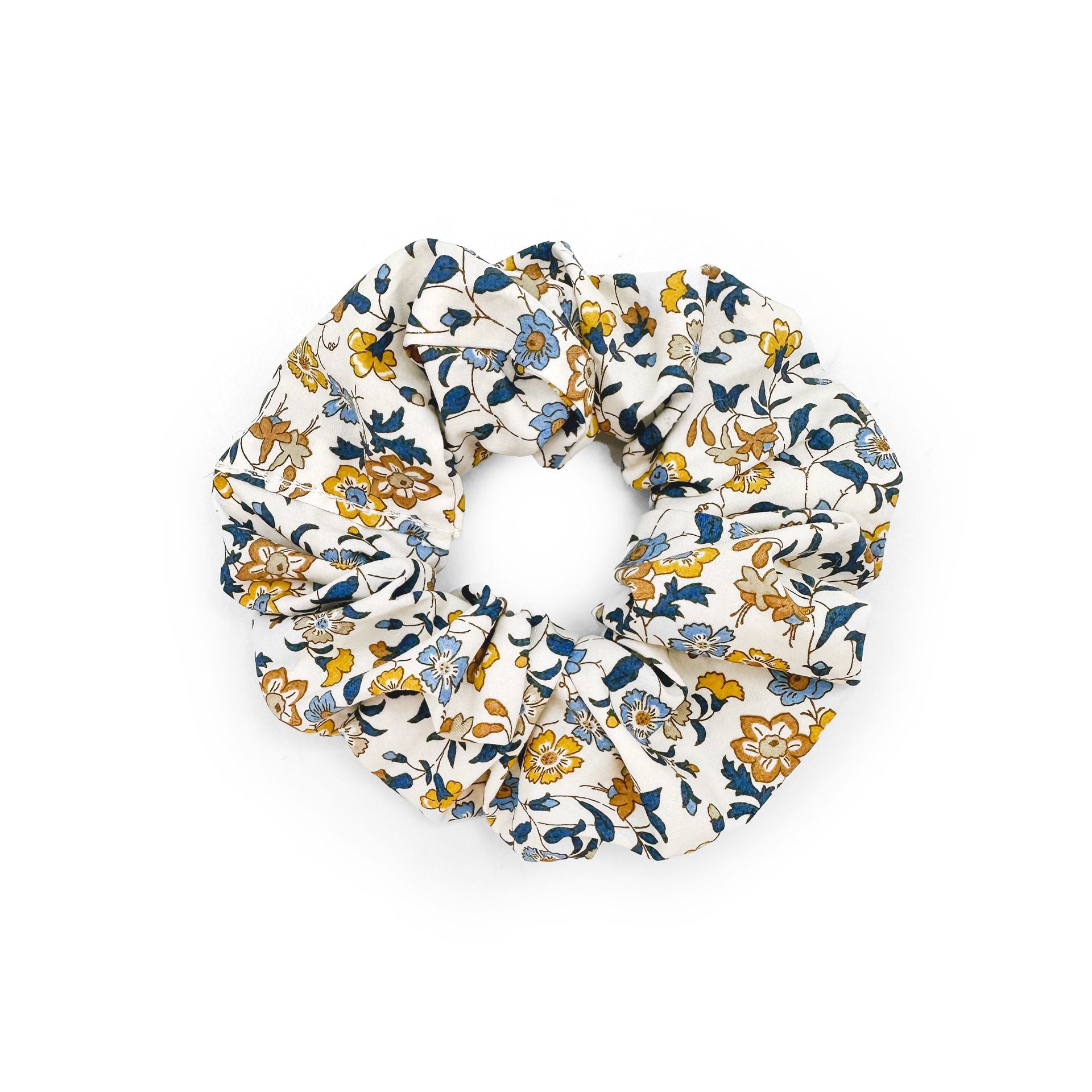 A white scrunchie with blue and yellow flowers on it